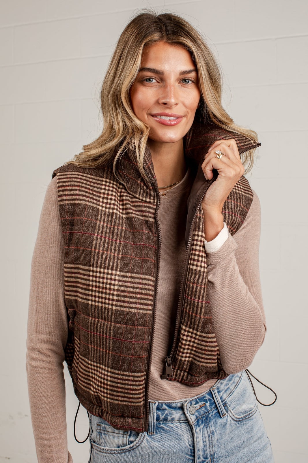Brown plaid puffer vest over neutral long-sleeve top Brown plaid puffer vest over neutral long-sleeve top — Brown Vest Outfit