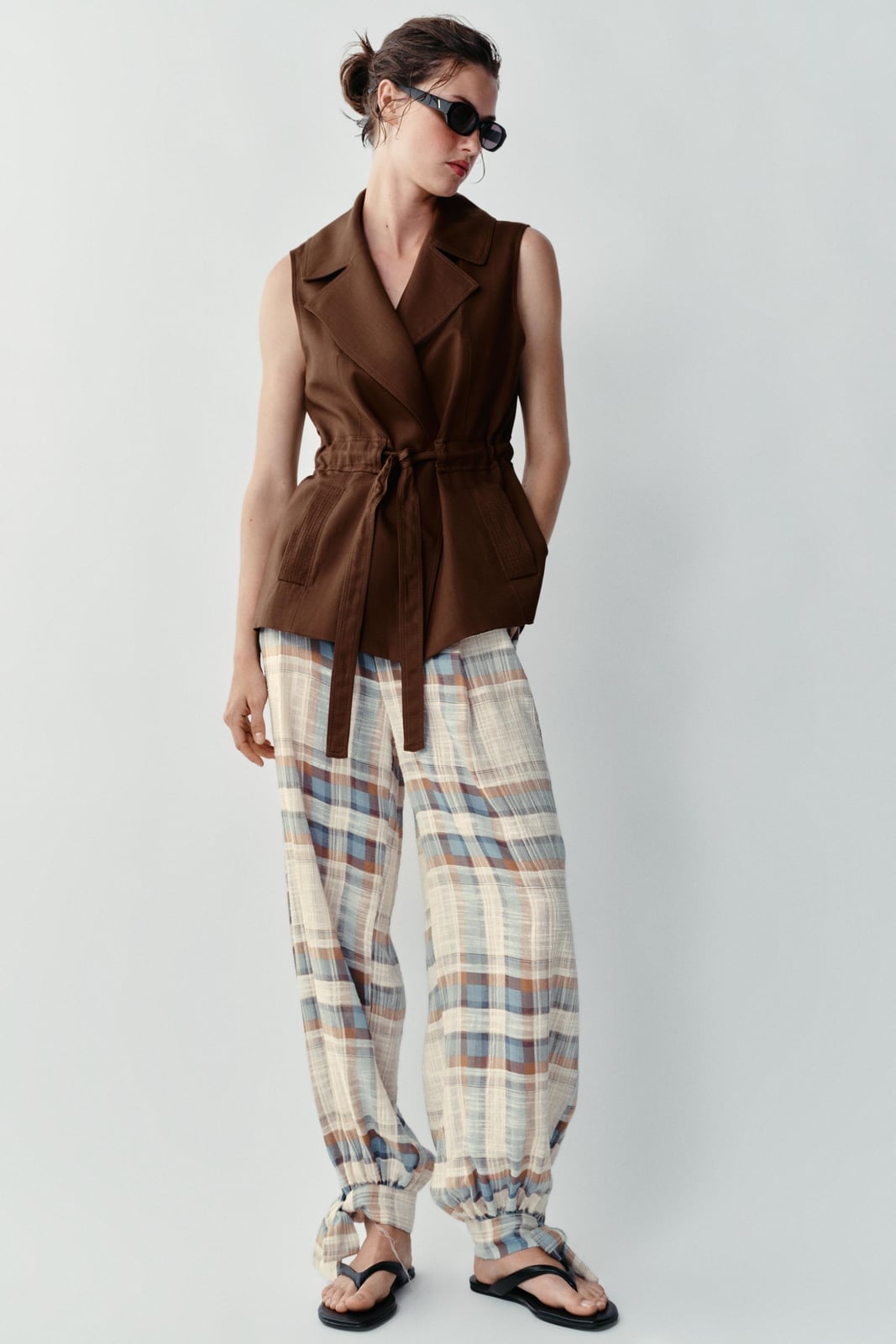 Brown belted vest over white top with plaid pants Brown belted vest over white top with plaid pants — Brown Vest Outfit