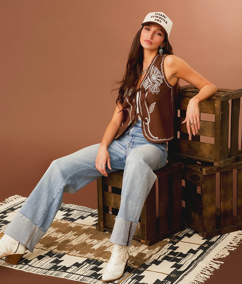 Brown embroidered suede vest over white top with jeans Brown embroidered suede vest over white top with jeans — Brown Vest Outfit