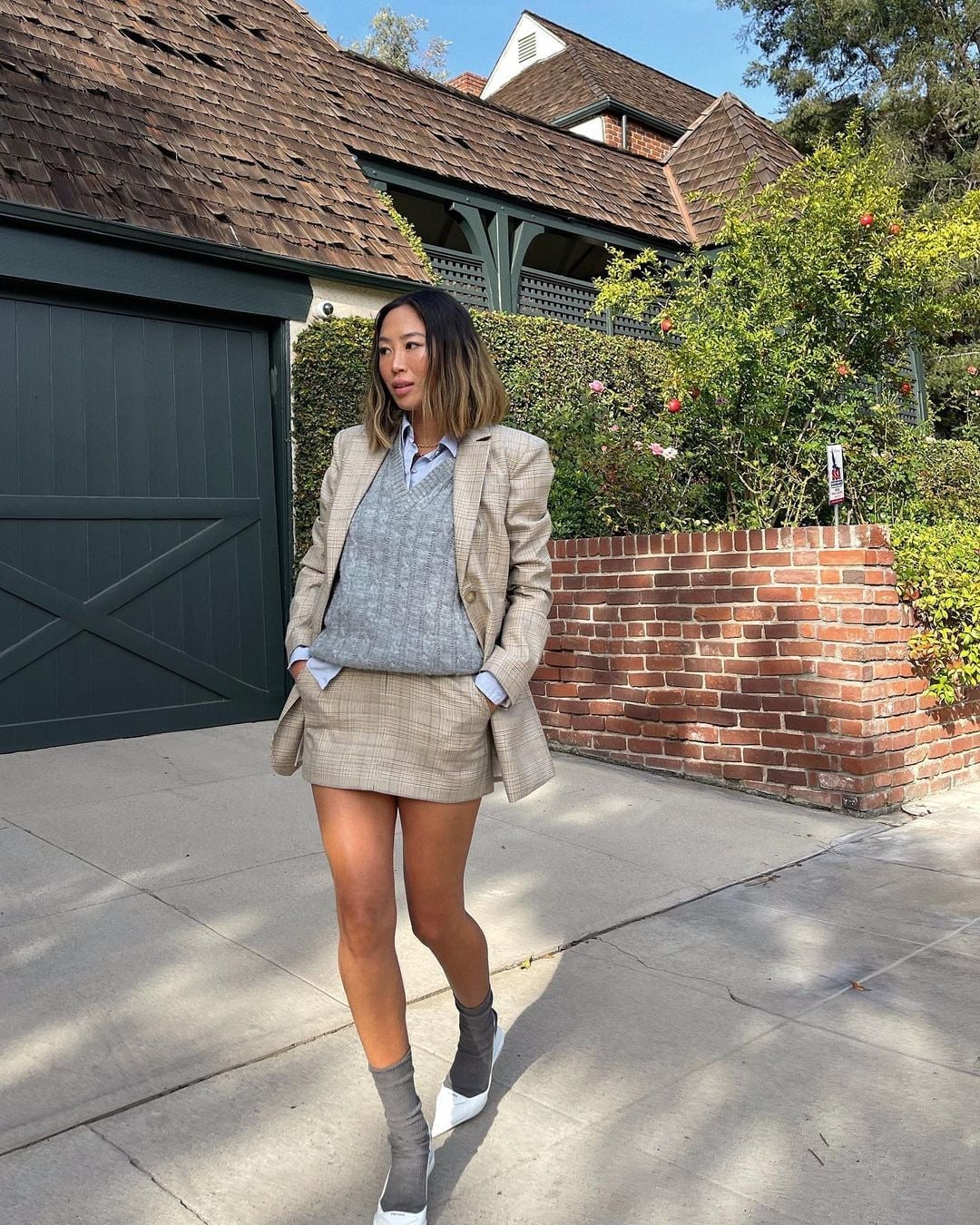 Plaid blazer layered over knit vest and button-down shirt Plaid blazer layered over knit vest and button-down shirt — Business Casual Outfits