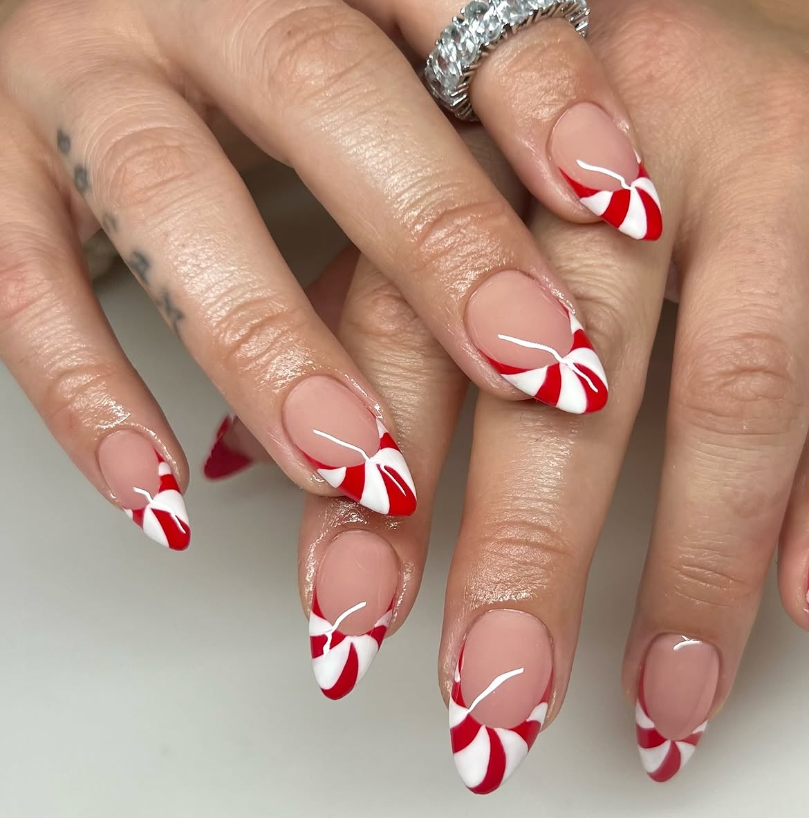 Candy Cane Swirl French Tip Almond Nails