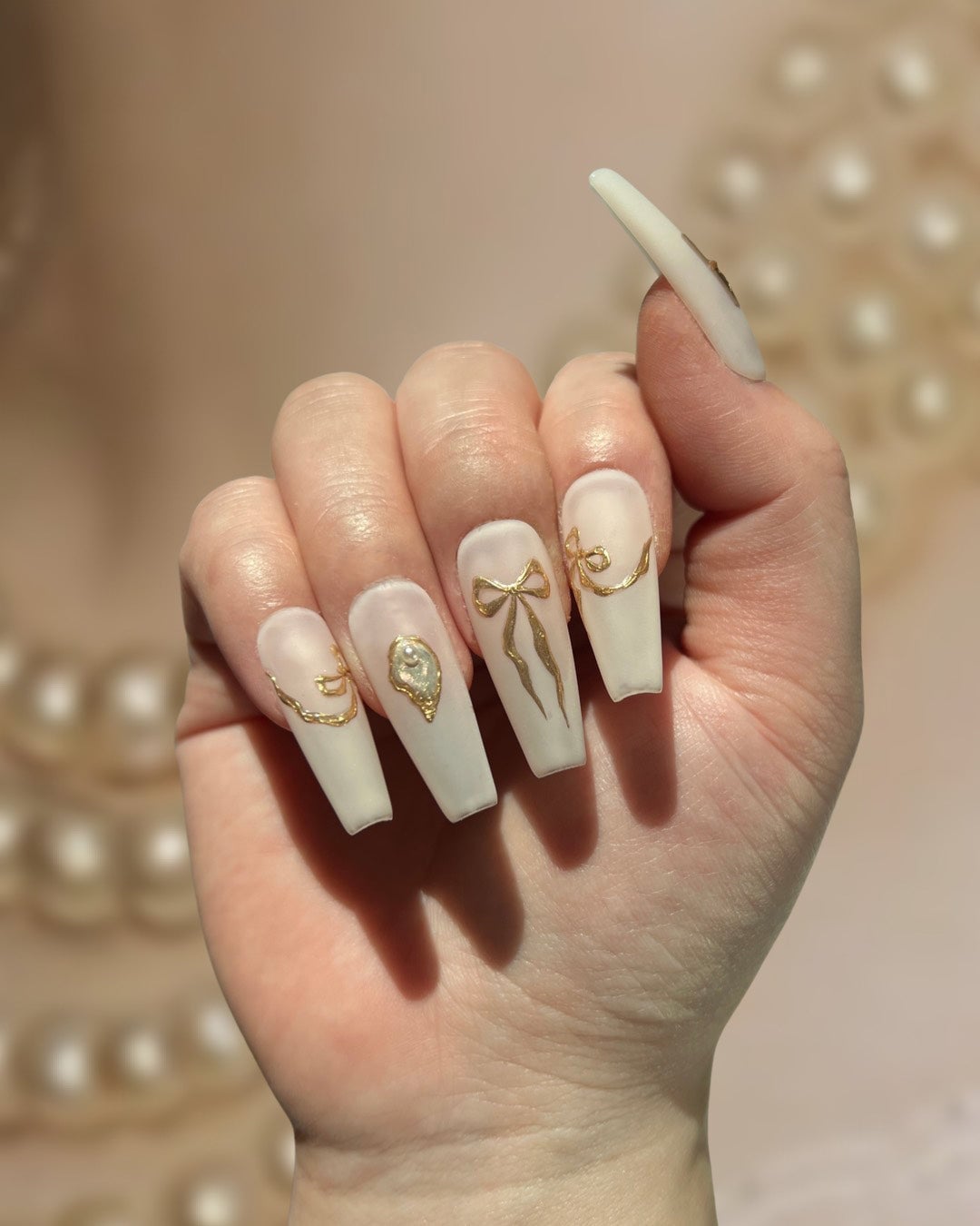 Long Stiletto Matte White Nails With Gold Bows Long Stiletto Matte White Nails With Gold Bows — Charm Nails