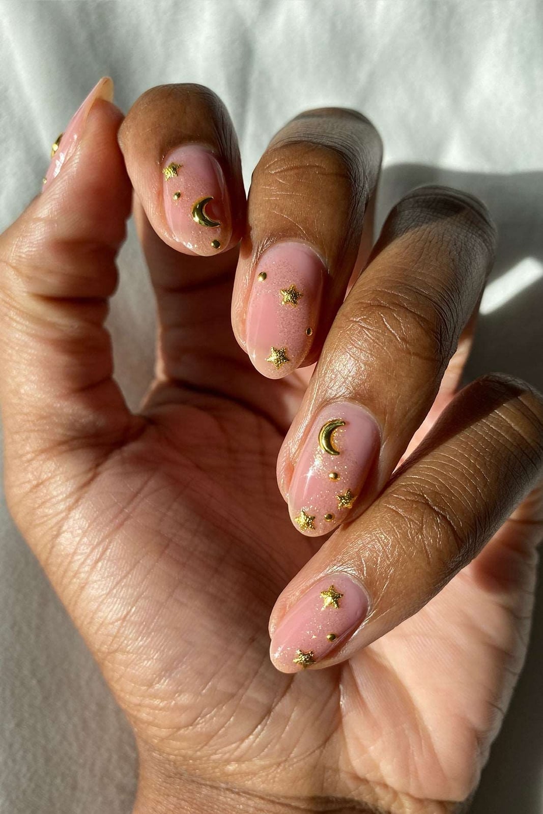 Short Oval Sheer Pink Nails With Celestial Charms Short Oval Sheer Pink Nails With Celestial Charms — Charm Nails