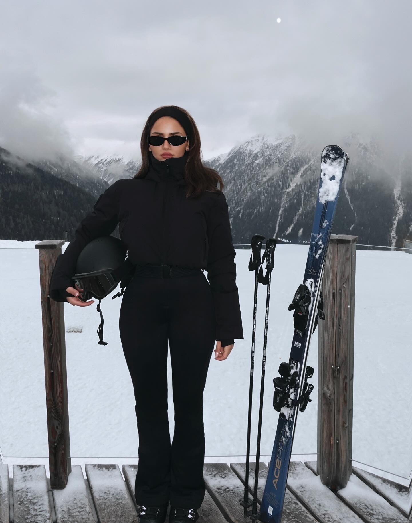 Chic All-Black Ski Suit With Sleek Accessories