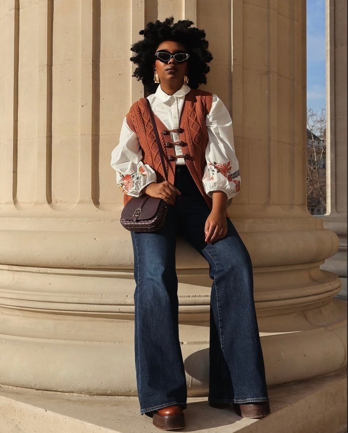Knit vest over embroidered blouse and wide-leg jeans Knit vest over embroidered blouse and wide-leg jeans — Chic Style