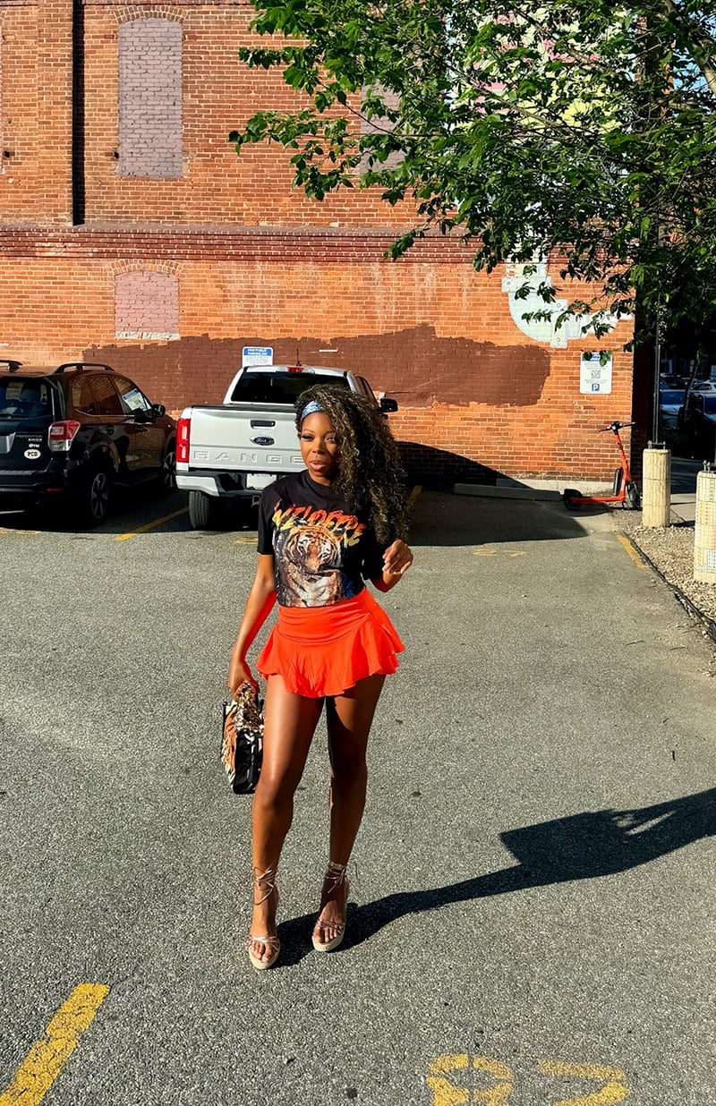 Black Graphic T-Shirt with Bright Orange Flared Mini Skirt Black Graphic T-Shirt with Bright Orange Flared Mini Skirt — Club Outfits Black Women