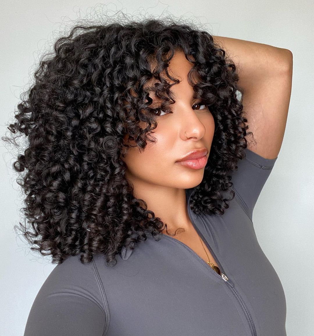 Collarbone Curly Hair With Lighter Brown Highlights and Face-Framing Collarbone Curly Hair With Lighter Brown Highlights and Face-Framing — Curly Hair with Bangs