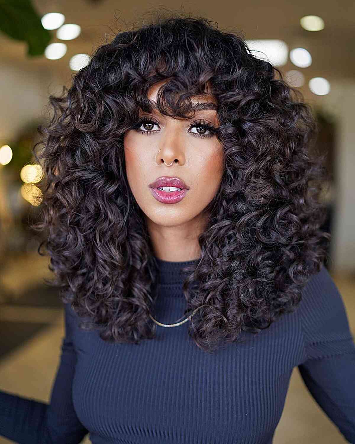 Collarbone Dark Brown Curls With Curtain Bangs Collarbone Dark Brown Curls With Curtain Bangs — Curly Hair with Bangs
