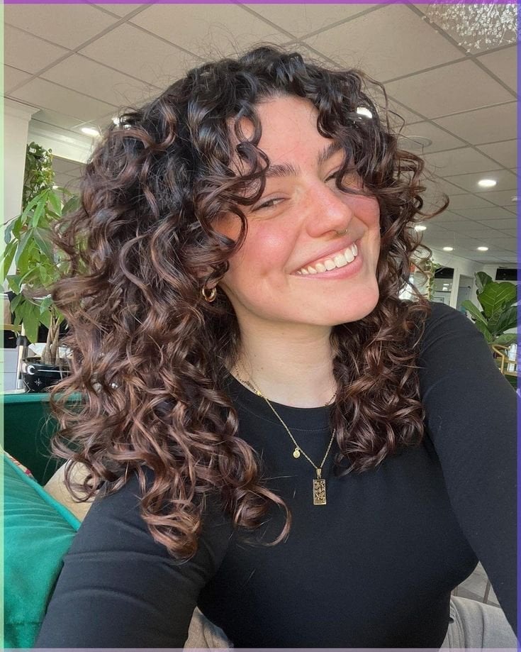 Mid-Back Curly Hair With Auburn Highlights and Voluminous Bangs Mid-Back Curly Hair With Auburn Highlights and Voluminous Bangs — Curly Hair with Bangs