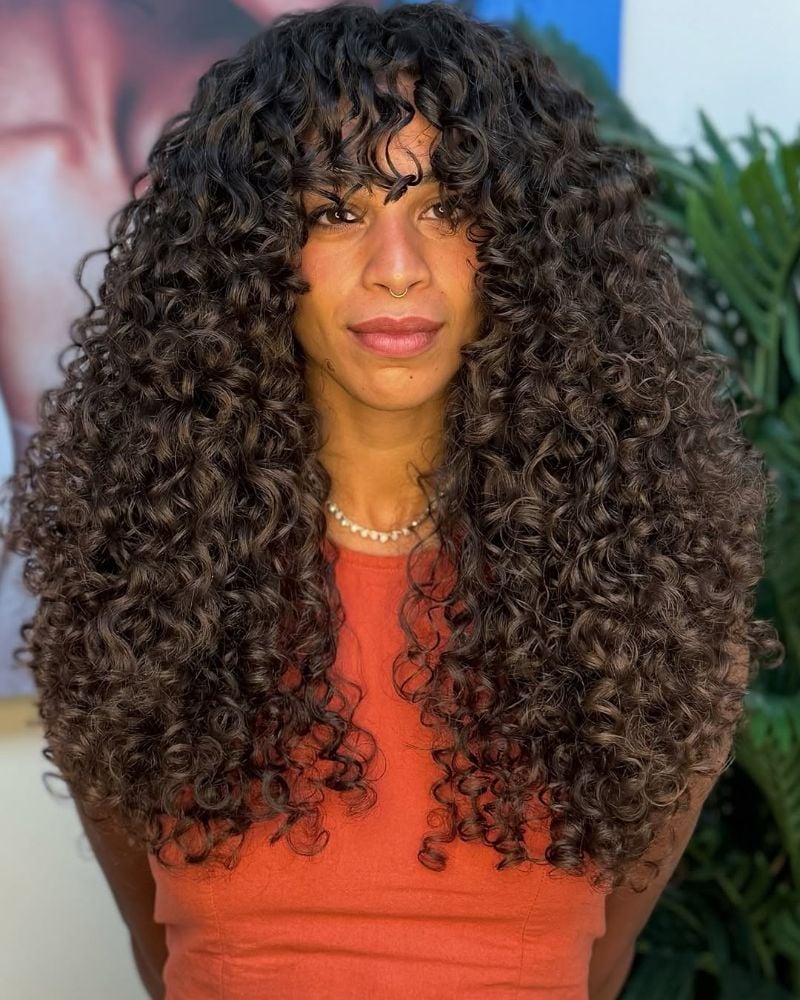 Mid-Back Curly Hair With Highlights and Soft Curtain Bangs Mid-Back Curly Hair With Highlights and Soft Curtain Bangs — Curly Hair with Bangs