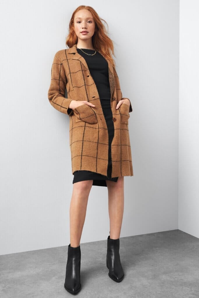 Brown plaid cardigan over black mini dress with ankle boots Brown plaid cardigan over black mini dress with ankle boots — Dark Academia Outfits