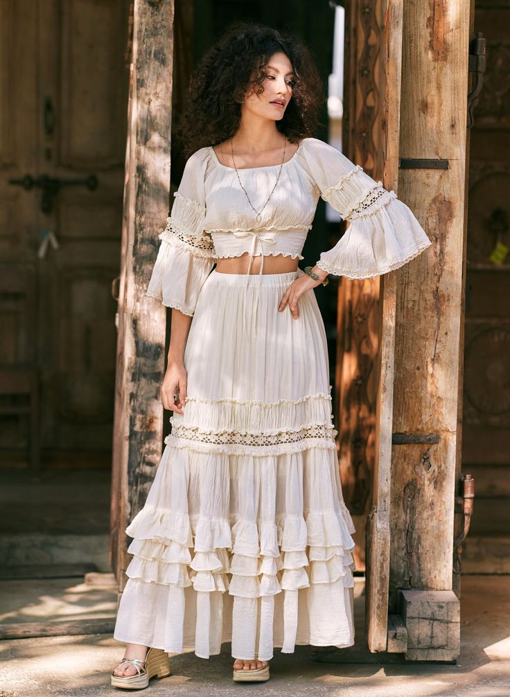 An off-white peasant top with voluminous bell sleeves and a tiered An off-white peasant top with voluminous bell sleeves and a tiered — Feminine Style
