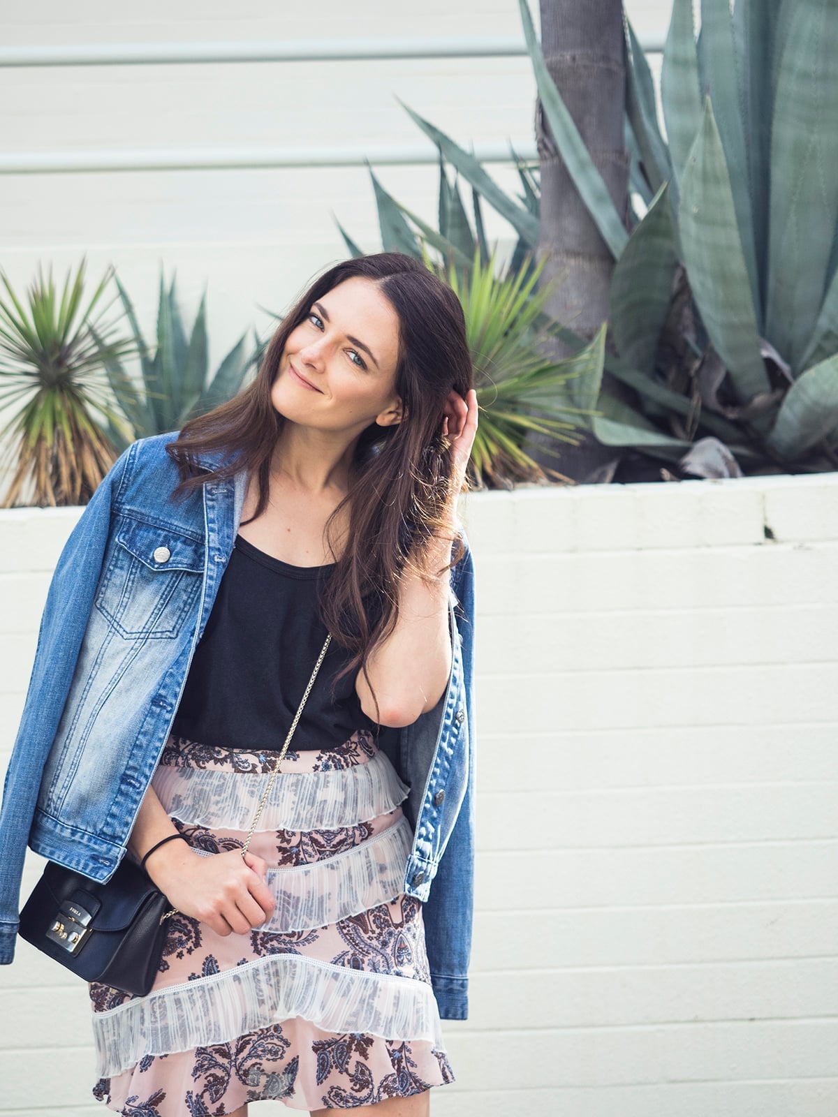 A denim jacket layered over a tank with a pink patterned tiered mini A denim jacket layered over a tank with a pink patterned tiered mini — Feminine Style