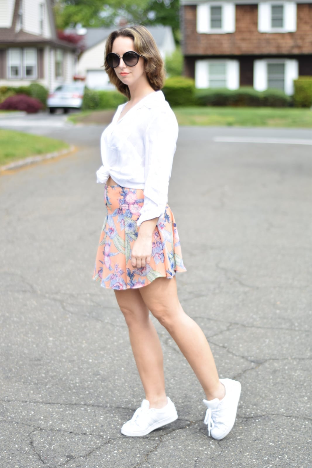 A white button-down tied over a pastel floral flared mini skirt A white button-down tied over a pastel floral flared mini skirt — Feminine Style