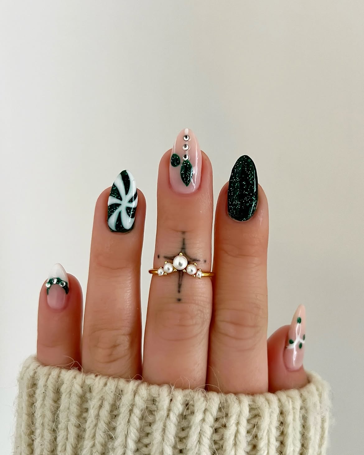 Festive Dark Green Winter Nail Art With Peppermint Swirls