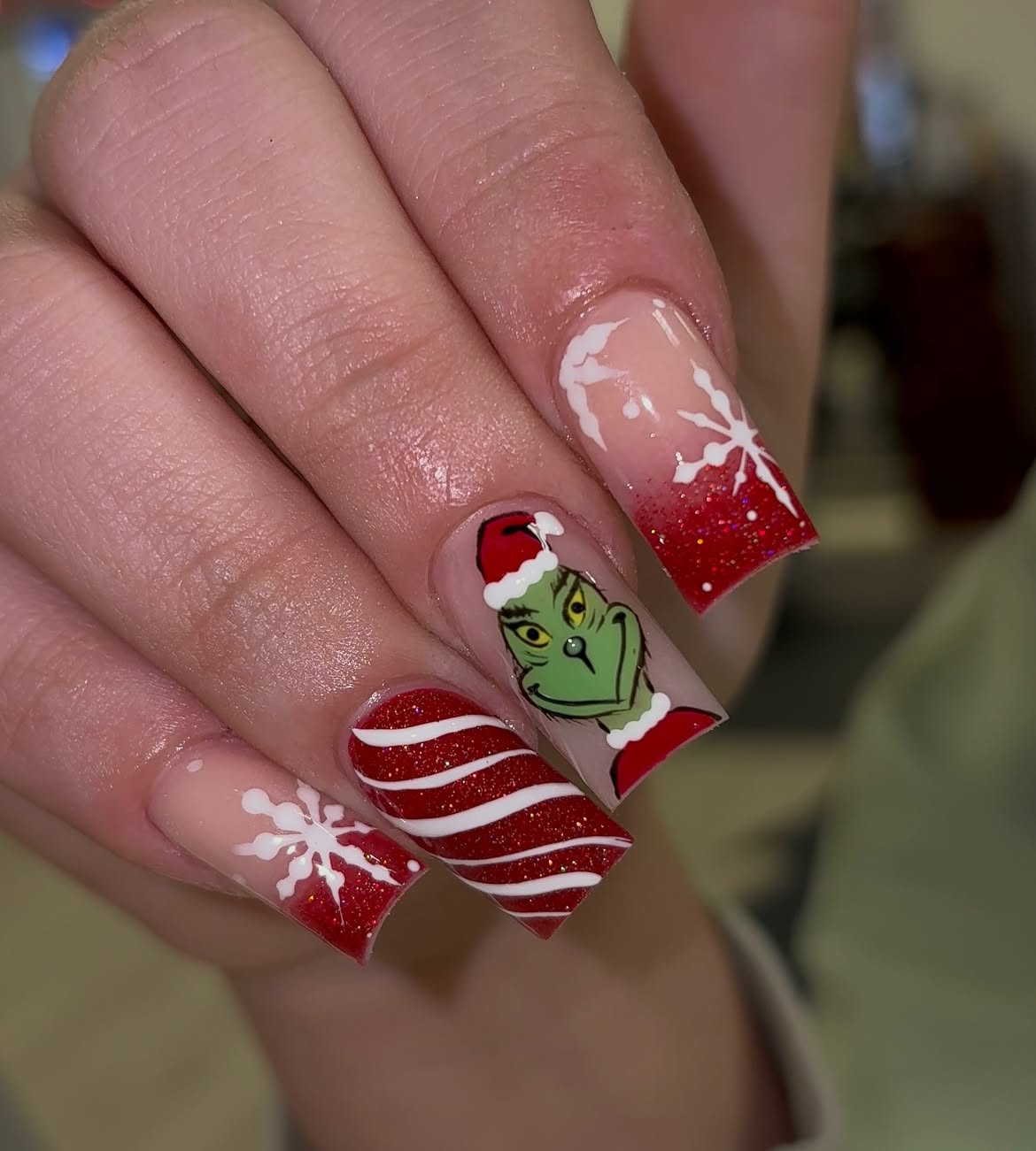 Festive Grinch Nail Art With Red Glitter And Snowflakes