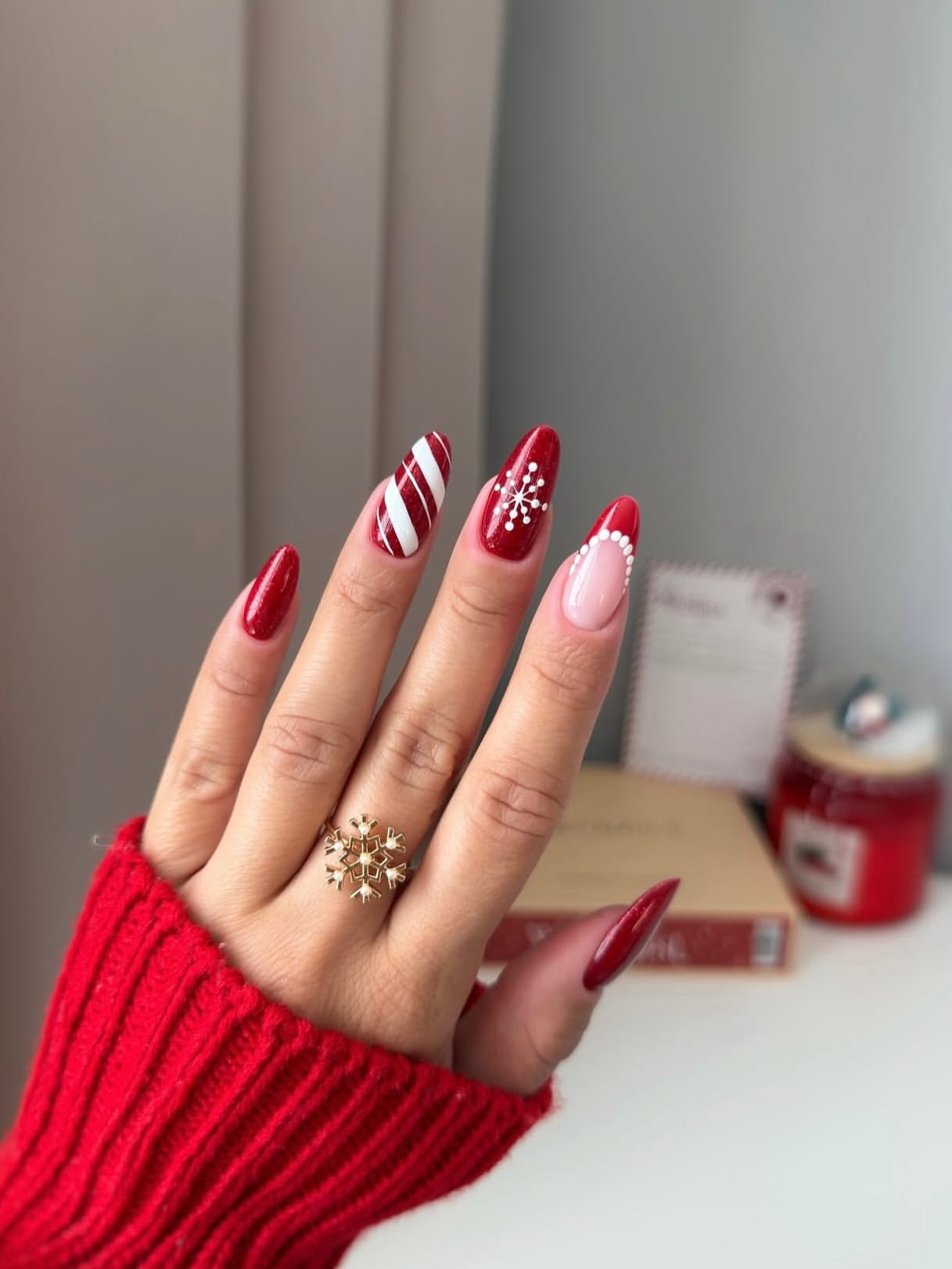 Festive Red Almond Nails with Candy Cane and Snowflake Art