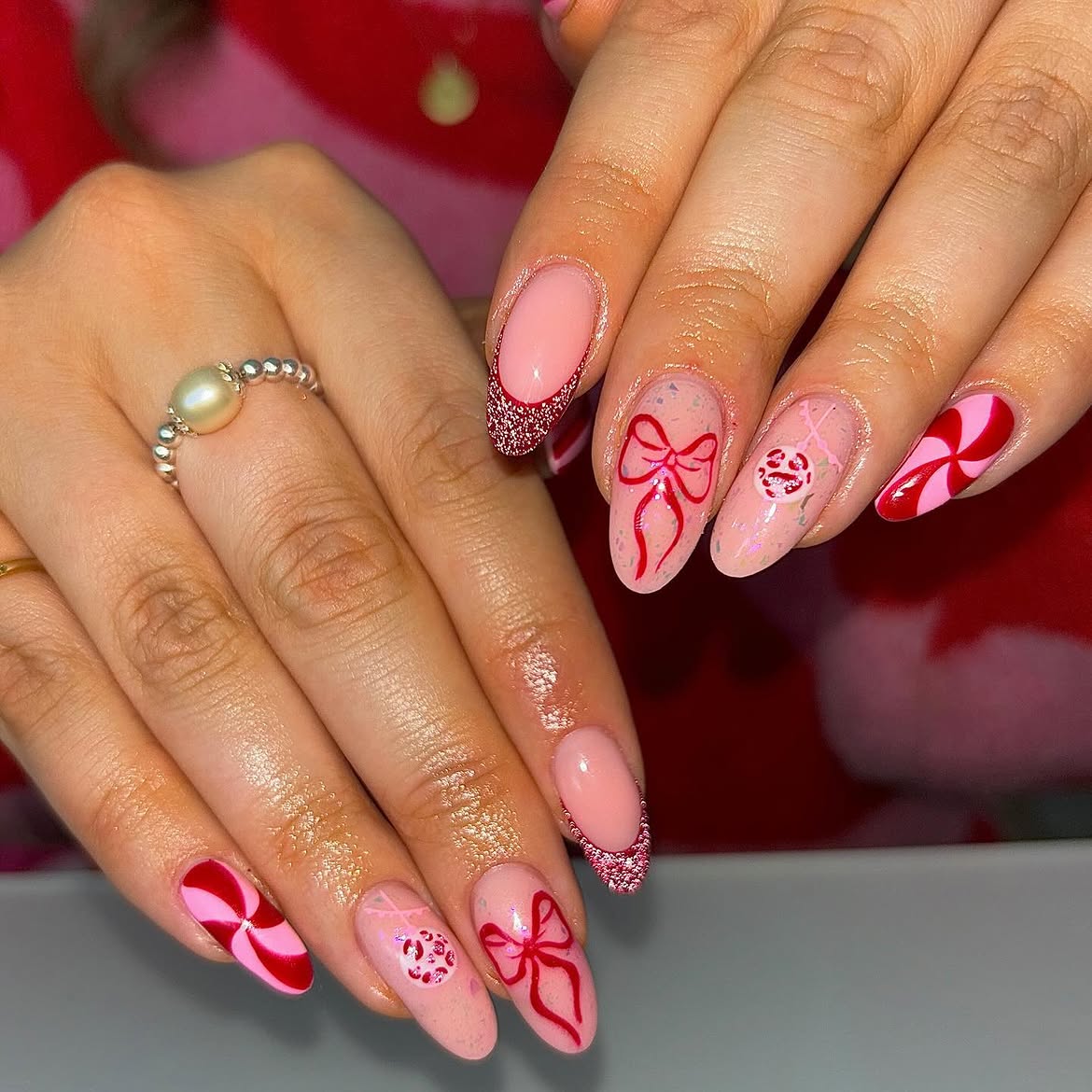 Festive Red Bows and Peppermint Swirl Almond Nails