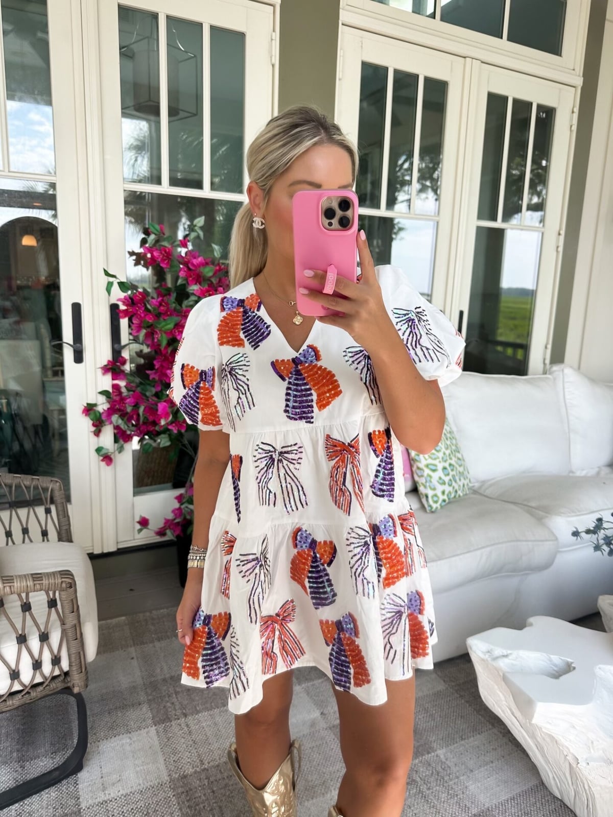 Tiered mini dress with bow print and gold cowboy boots Tiered mini dress with bow print and gold cowboy boots — Game Day Outfits