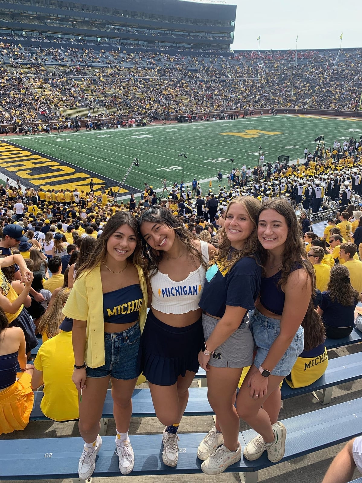 Yellow cardigan over bandeau top and denim shorts for game day Yellow cardigan over bandeau top and denim shorts for game day — Game Day Outfits