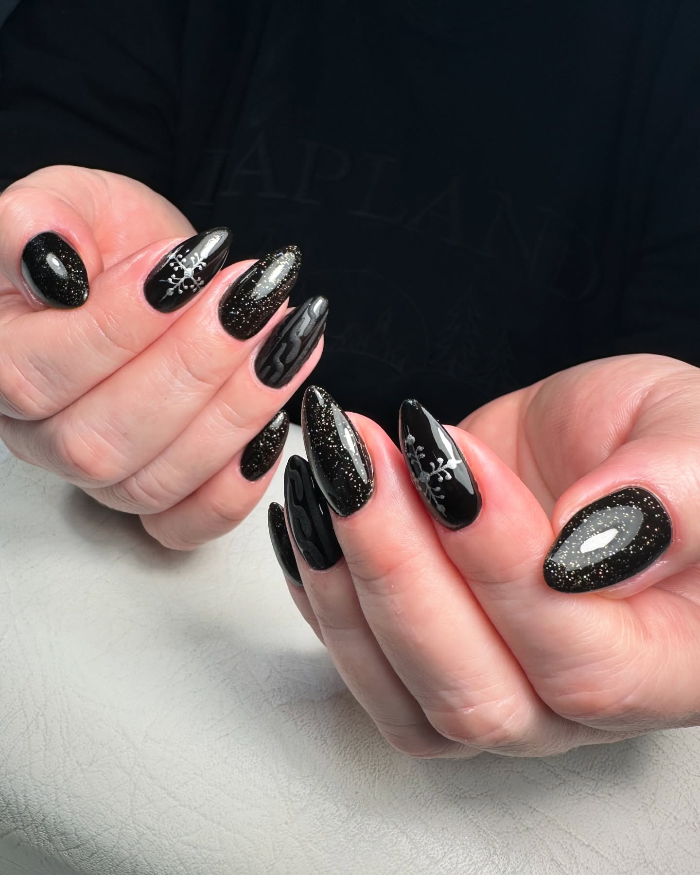 Glistening Black Snowflake Almond Nails