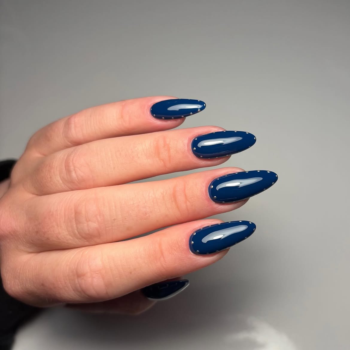 Glossy Navy Blue Almond Nails with Stud Accents