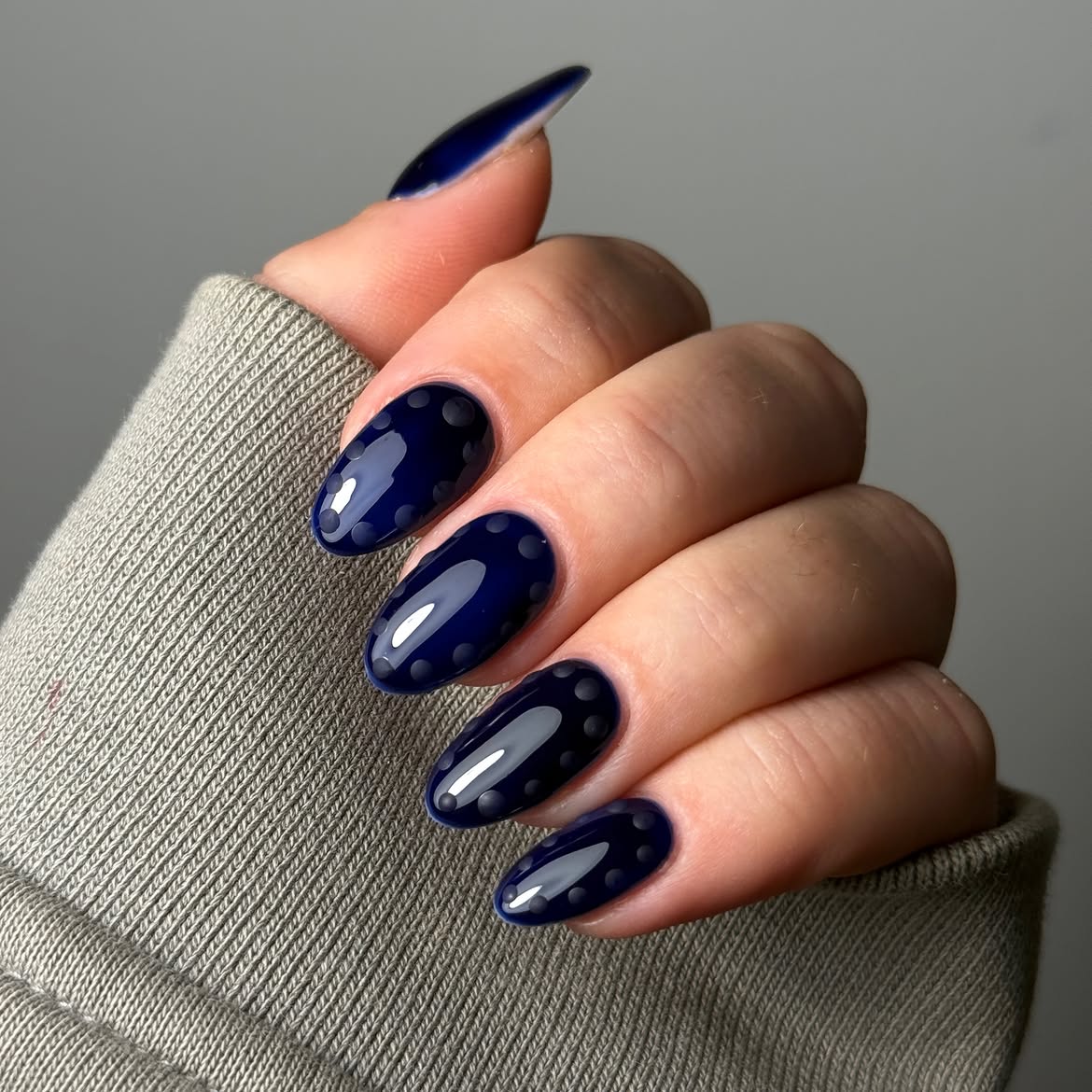 Glossy Navy Blue Oval Nails with Matte Dot Accents