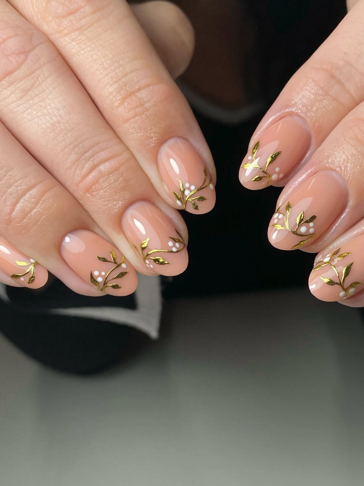 Glossy Nude Almond Nails With Gold Foliage