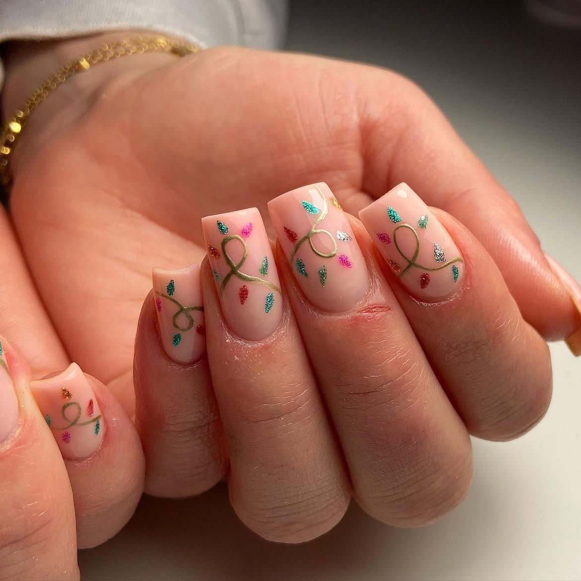 Glossy Nude Nails With Festive Christmas Lights Art