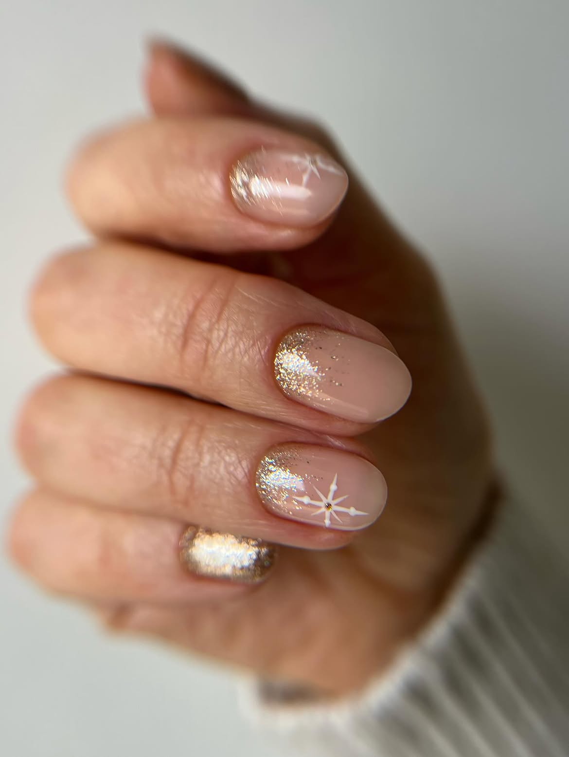 Glossy Nude Nails with Gold Glitter Cuticle Accent