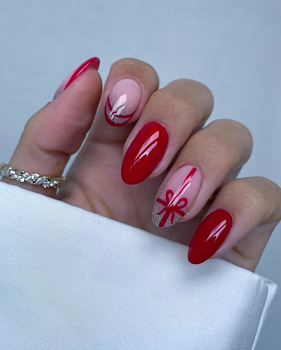 Glossy Red Almond Nails With Gift Bow Art