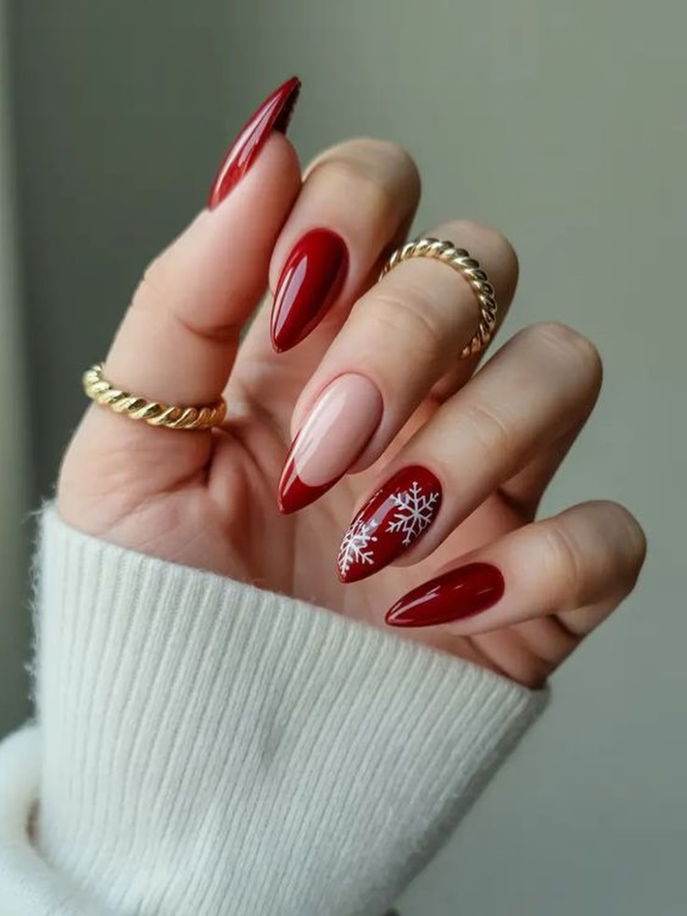 Glossy Red Almond Nails With White Snowflakes