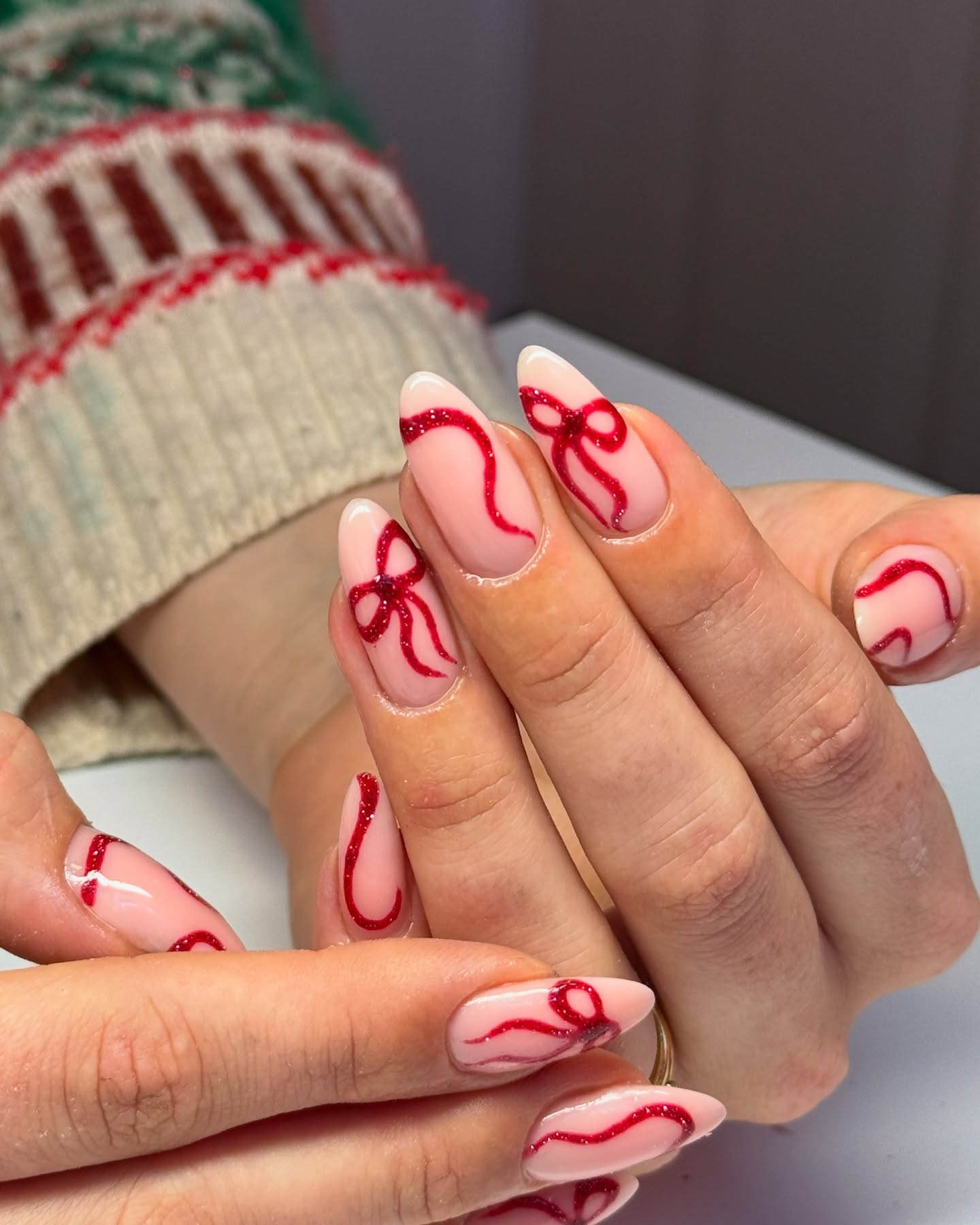 Glossy Red Glitter Bow Almond Nails