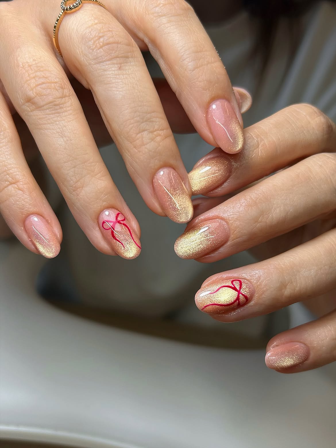 Gold Cat Eye Nails With Red Bow Art
