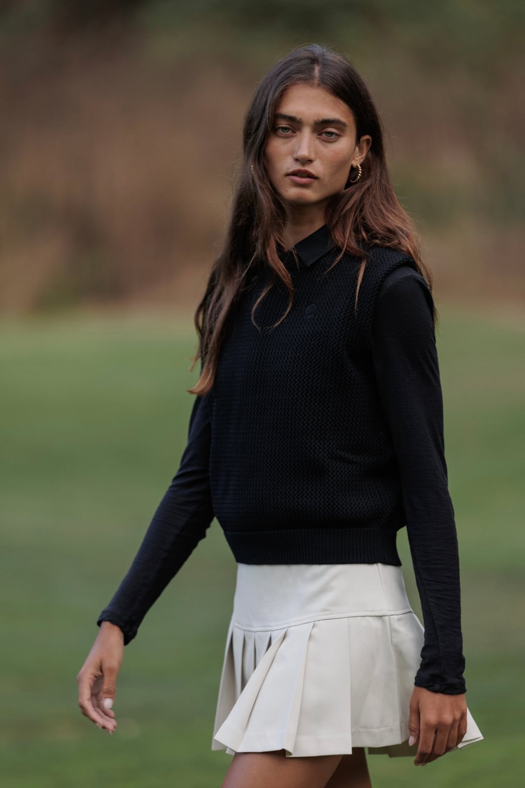 Black vest over long-sleeve shirt and cream skirt Black vest over long-sleeve shirt and cream skirt — Golf Outfits