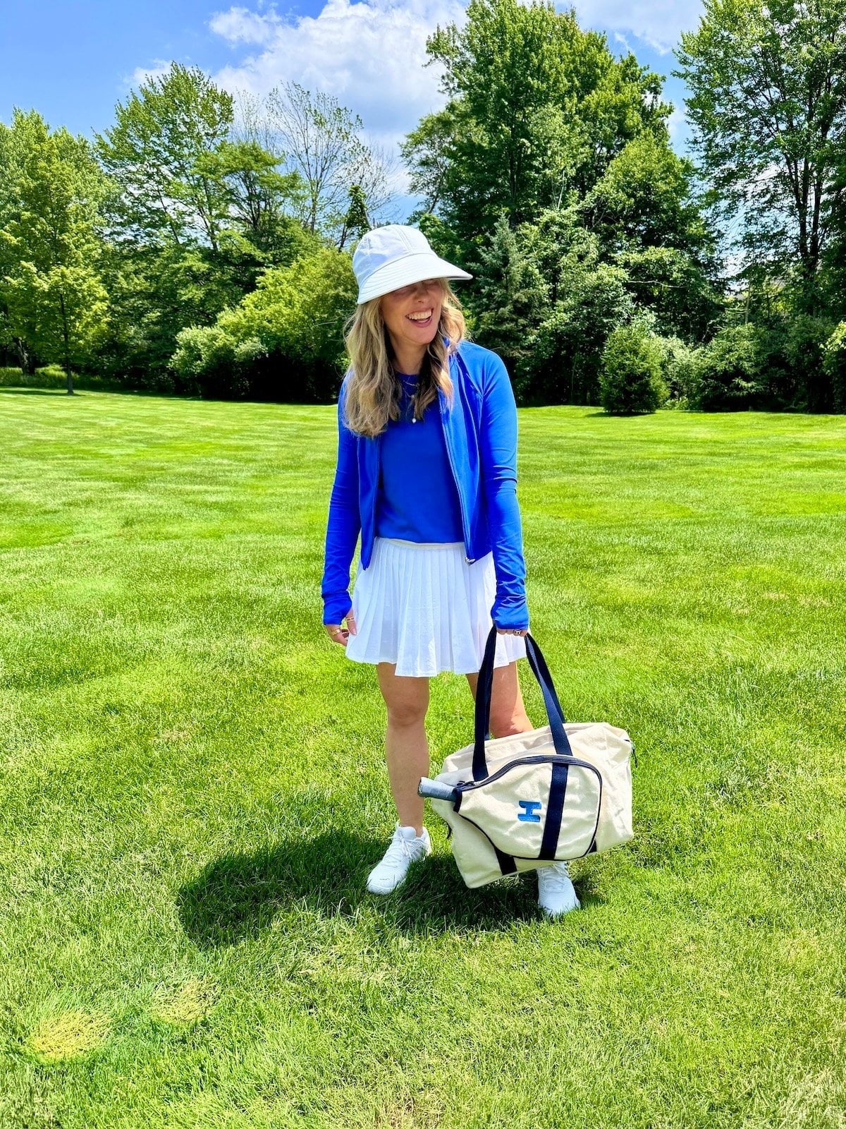 White pleated skirt with royal blue zip-up jacket White pleated skirt with royal blue zip-up jacket — Golf Outfits
