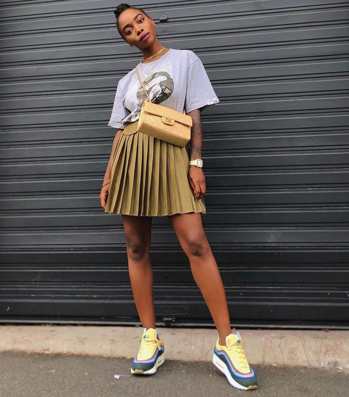 Camouflage Graphic Tee With Pleated Mini Skirt And Sneakers Camouflage Graphic Tee With Pleated Mini Skirt And Sneakers — Graphic Tee Outfits