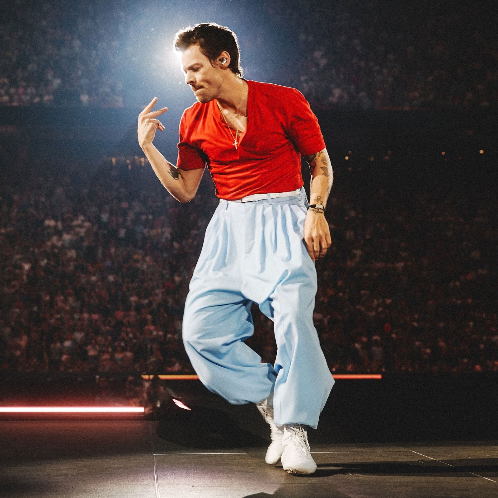 Red V-Neck Top and Voluminous Blue Trousers Red V-Neck Top and Voluminous Blue Trousers — Harry Styles Outfits