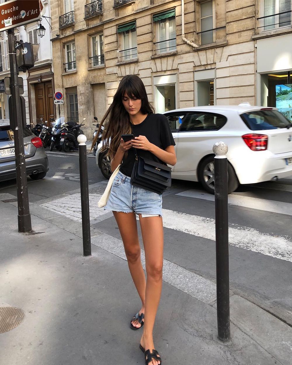 Distressed light wash denim shorts with a beige oversized shirt, Black Distressed light wash denim shorts with a beige oversized shirt, Black — Jean Shorts Outfits