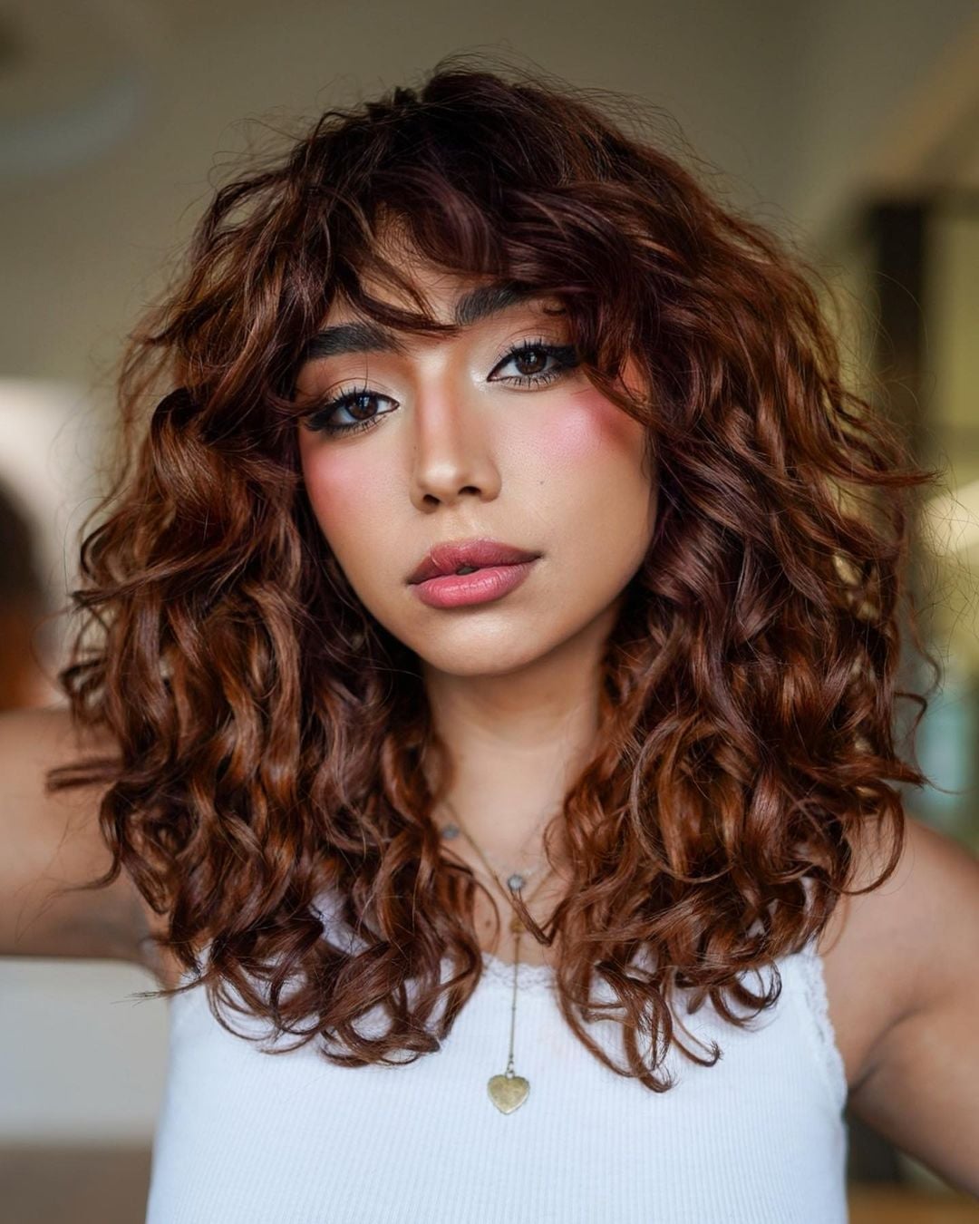 Layered Curly Bob With Auburn Highlights Layered Curly Bob With Auburn Highlights — Layers Hair