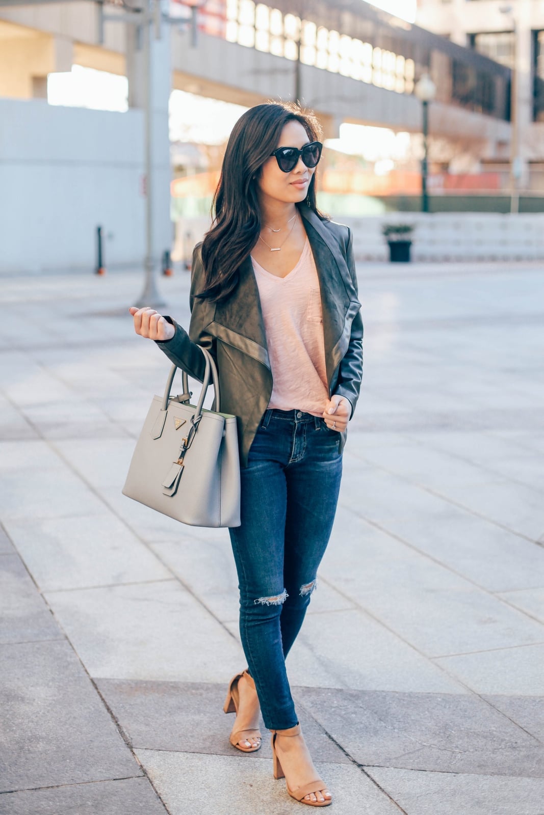 Dark gray leather jacket with pink top and distressed jeans Dark gray leather jacket with pink top and distressed jeans — Leather Jacket Outfits Women