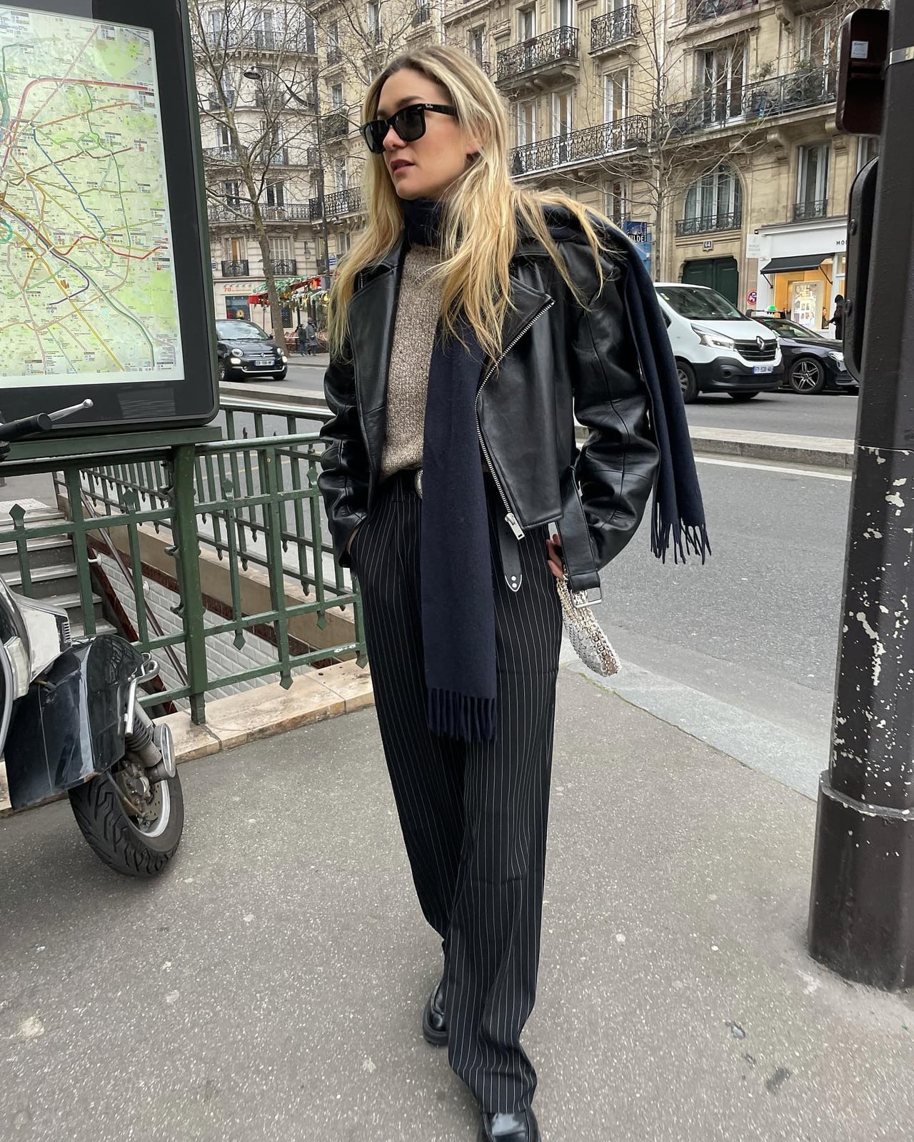 Black leather jacket over beige knit sweater with pinstripe trousers Black leather jacket over beige knit sweater with pinstripe trousers — Leather Jacket Outfits Women