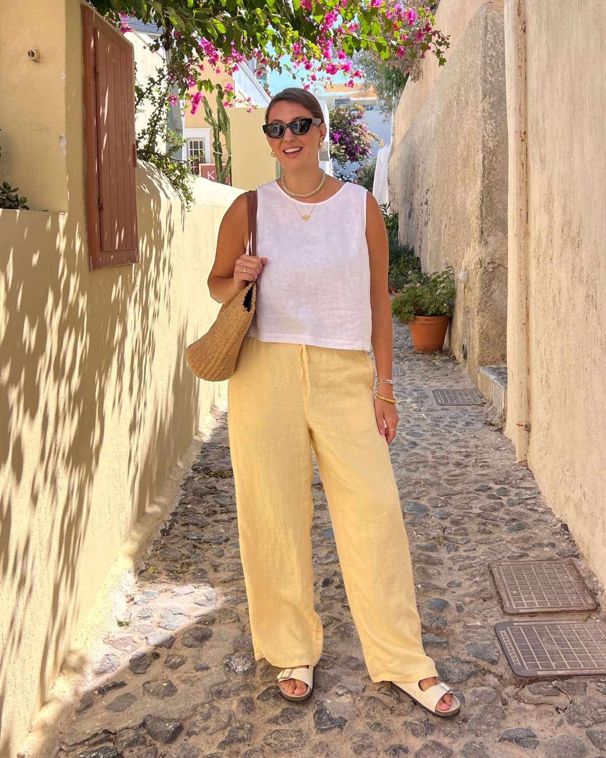 Yellow wide-leg linen trousers with a white tank and straw tote Yellow wide-leg linen trousers with a white tank and straw tote — Linen Pants Outfits