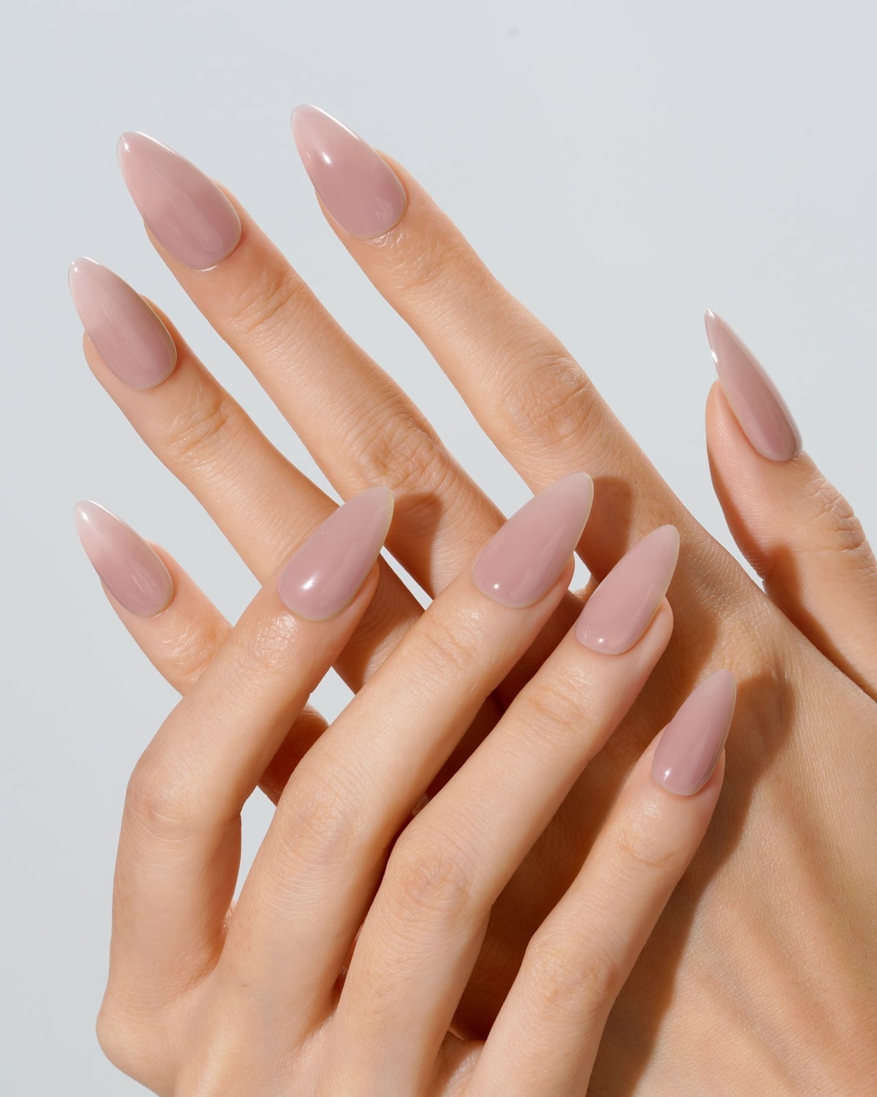 Glossy Neutral Pinkish-Beige Solid Color Almond Nails Glossy Neutral Pinkish-Beige Solid Color Almond Nails — Medium Almond Nails