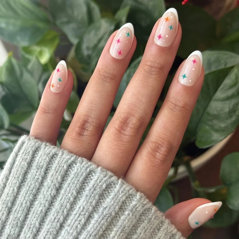 Nude White French Almond Nails With Colorful Stars Nude White French Almond Nails With Colorful Stars — Medium Nails