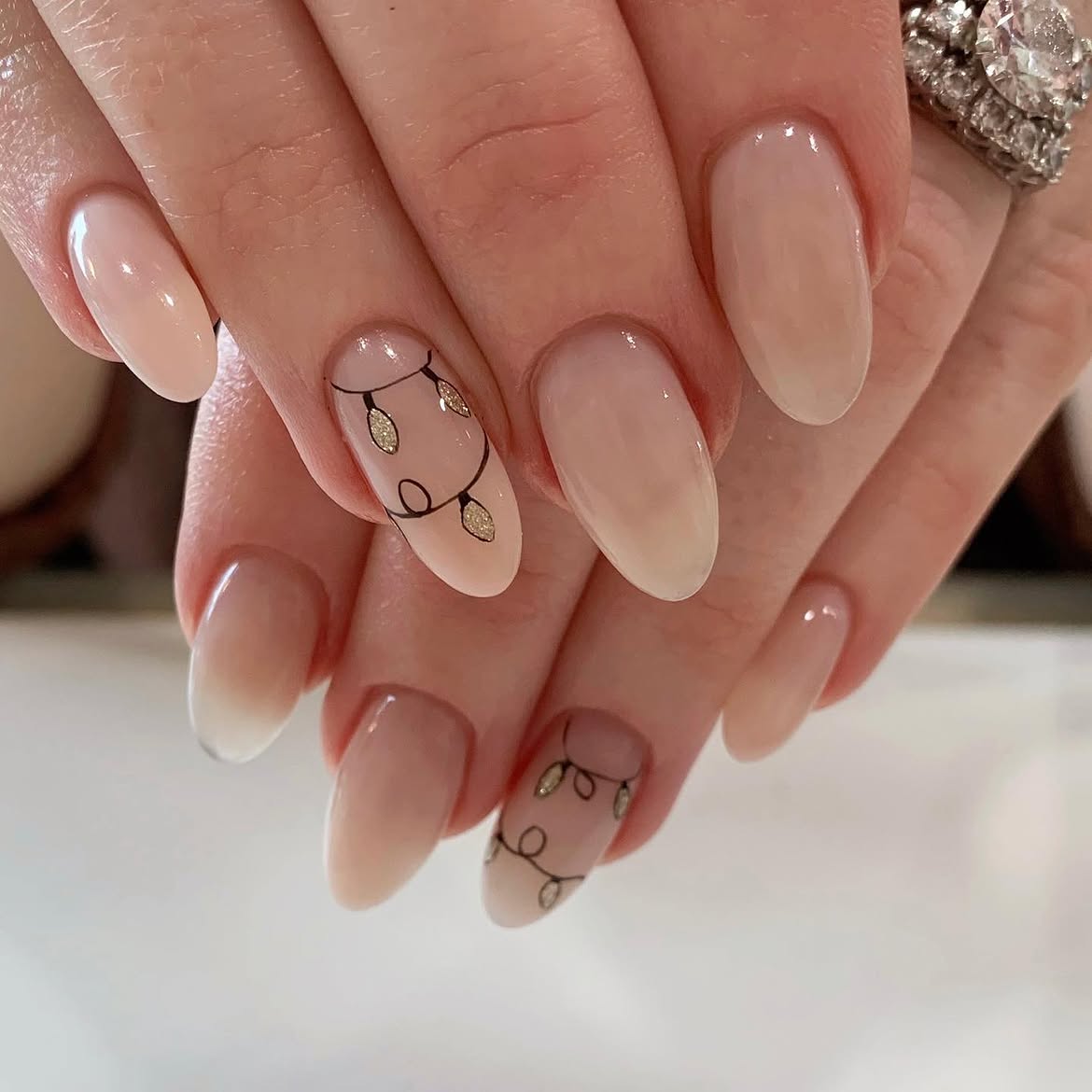 Milky Nude Almond Nails With Christmas Lights Art