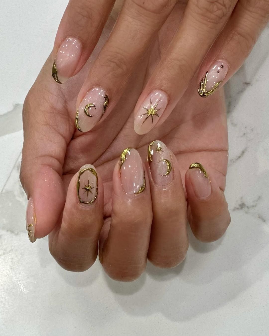 Medium Oval Nude With Gold Celestial Motifs Medium Oval Nude With Gold Celestial Motifs — Minimalist Nails