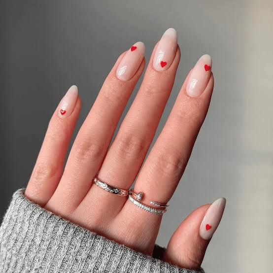 Medium Almond Sheer Nude With Red Heart Accents Medium Almond Sheer Nude With Red Heart Accents — Minimalist Nails