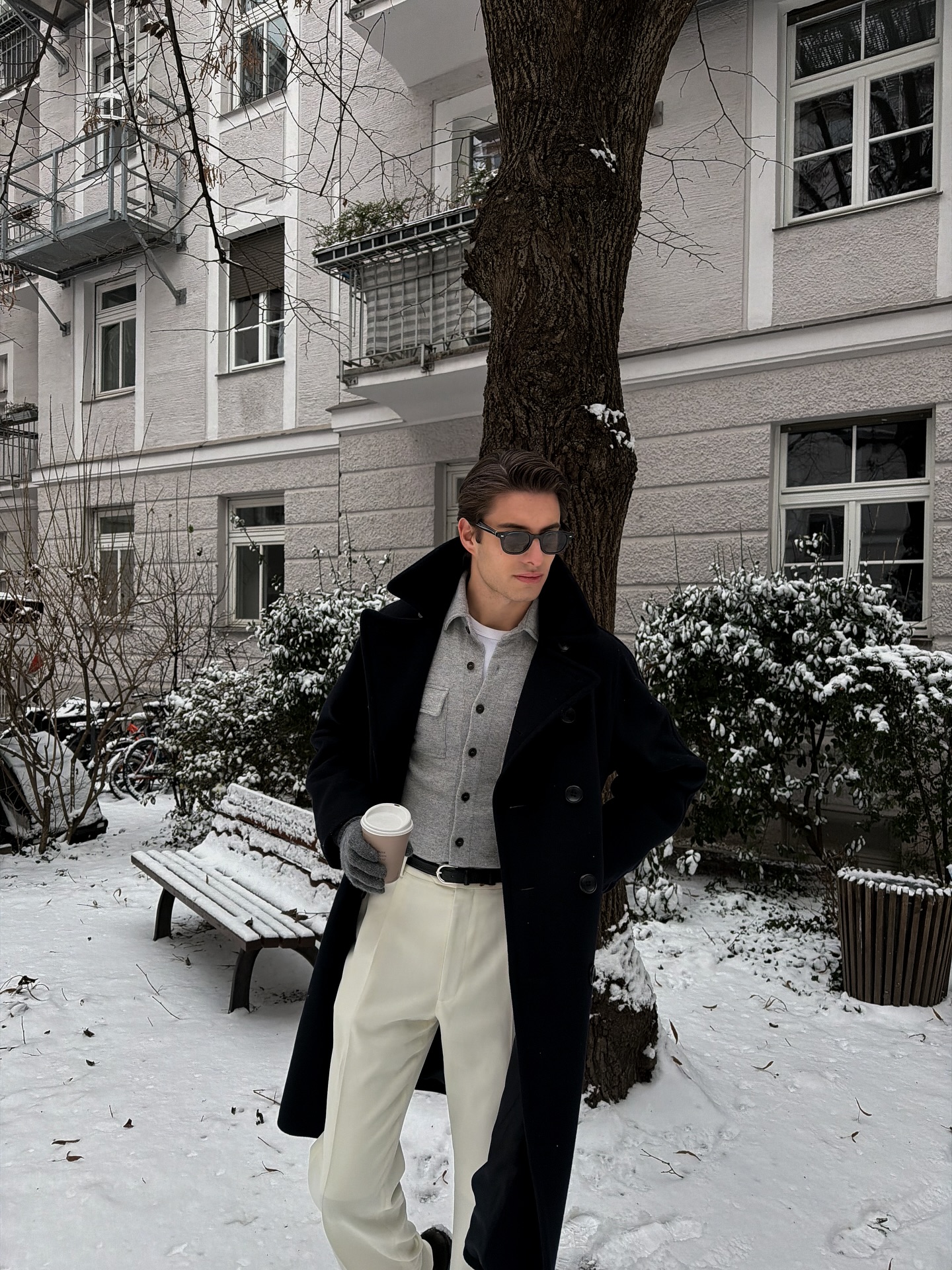 Monochrome Layers With Cream Trousers And Black Overcoat