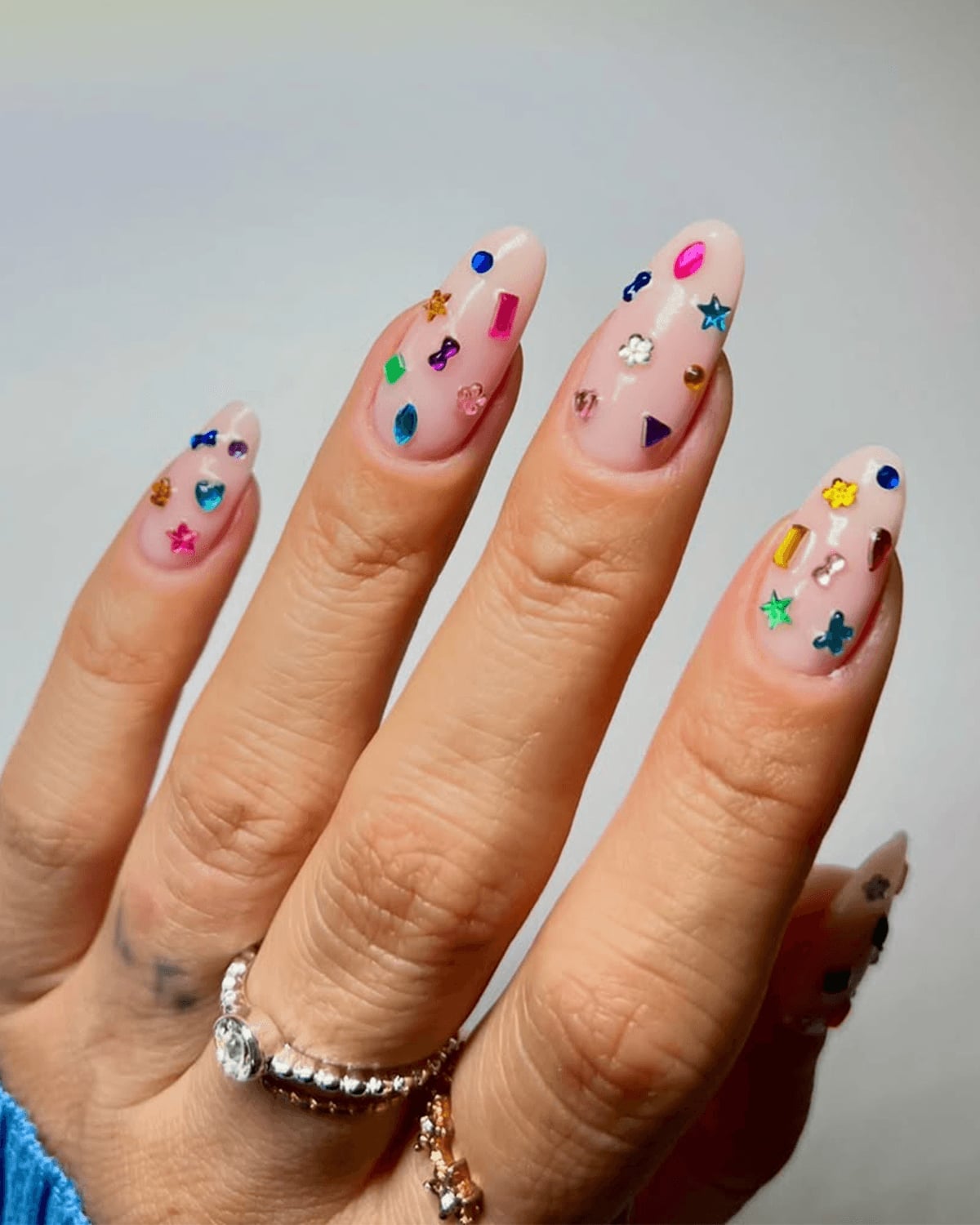 Short Almond Nails with Pink Base and Mixed Charms Short Almond Nails with Pink Base and Mixed Charms — Nails with Gems